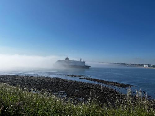 a large ship on the water in the ocean at Village view apartments in Tynemouth