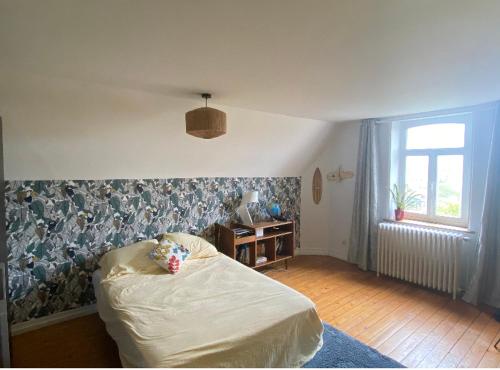 En eller flere senge i et værelse på Villa « LA CHARMANTE »