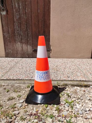 an orange and white traffic cone sitting on the ground at Residence Fragole Apartment Venice in Campalto