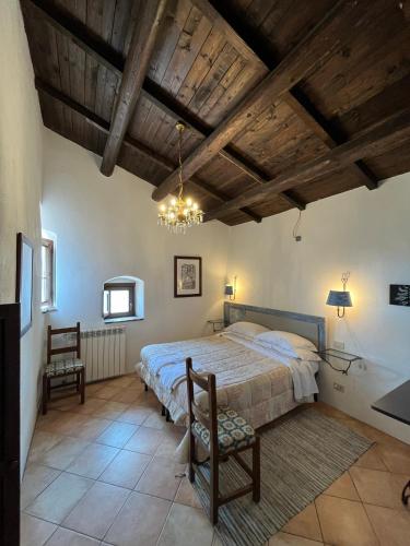 a bedroom with a large bed and a wooden ceiling at La Taberna di Rocca Calascio in Calascio