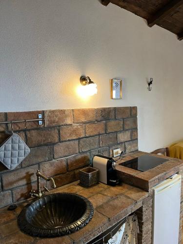 a bathroom with a stone counter with a sink at La Taberna di Rocca Calascio in Calascio