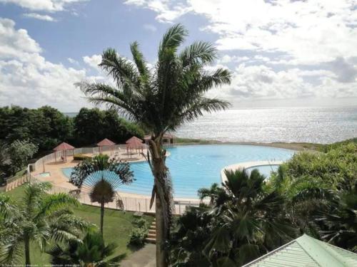 an image of a swimming pool at a resort at studio Ti’Gwada Family in Saint-François