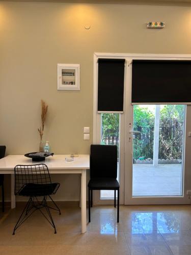 an office with a desk and two chairs and a window at Aventora Apartments in Lygia