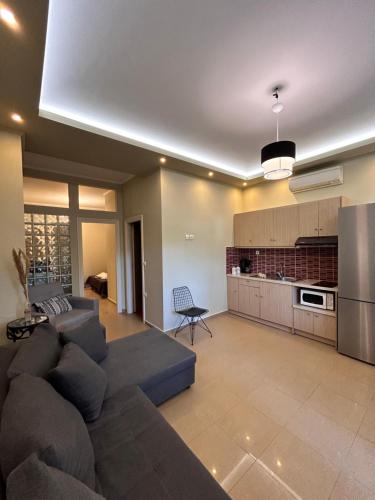 a living room with a couch and a kitchen at Aventora Apartments in Lygia