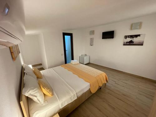 a bedroom with a large bed in a room at Vila Lorena in Mangalia