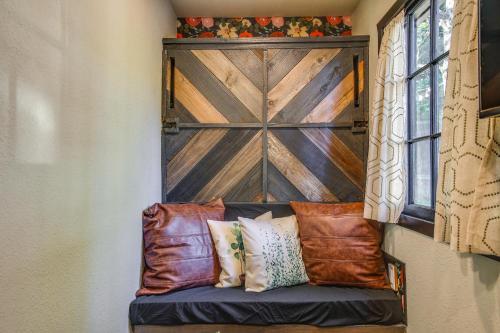a bench in a room with a wooden door at Lakewood Vacation Rental - Walk to American Lake! in Tacoma