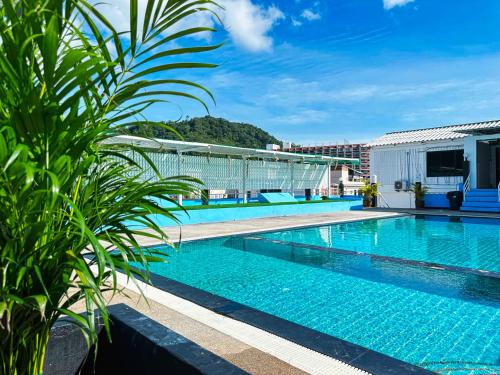 a pool on the roof of a building at Hotel Baya Phuket - Rooftop Pool, Next to Food Market & Steps to Beach in Patong Beach