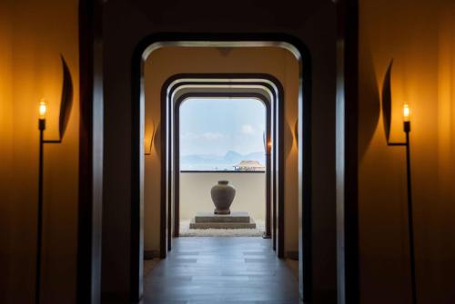 a hallway with a view of a vase in the distance at Hotel Soleil Ha Long, Trademark Collection by Wyndham in Ha Long