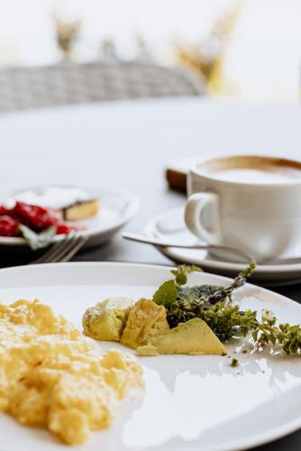 a plate of food on a table with a cup of coffee at FAVAI HILLS your secret hideaway in Brenzone sul Garda