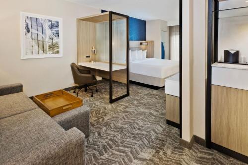 a hotel room with a couch and a bed at SpringHill Suites Birmingham Colonnade in Birmingham