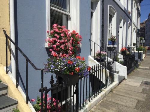 a balcony with flower boxes on a house at The ArtWorks in Hastings