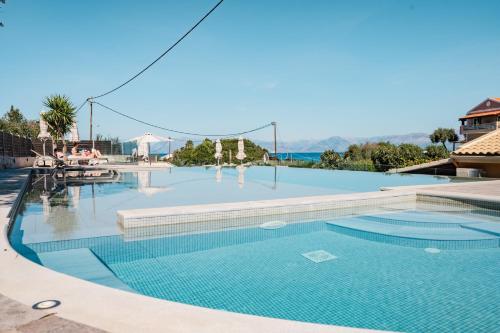 a swimming pool in a resort with people playing at Pyramid City Apartments in St. Spyridon Corfu