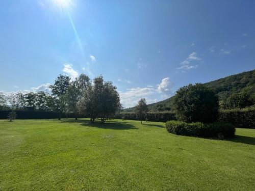 a large green field with trees in the distance at casa rústica in Olot