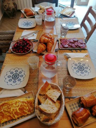 a table topped with plates of bread and pastries at HedèraRooms in Agerola