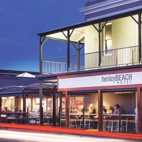 a restaurant with tables and chairs in front of a building at The Sea Haven 200m to Henley Beach in Henley Beach