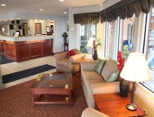 a living room with a couch and a table at Baymont by Wyndham Rolla in Rolla