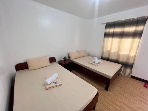 Ένα ή περισσότερα κρεβάτια σε δωμάτιο στο CEBUANA'S TRAVELERS INN Coron