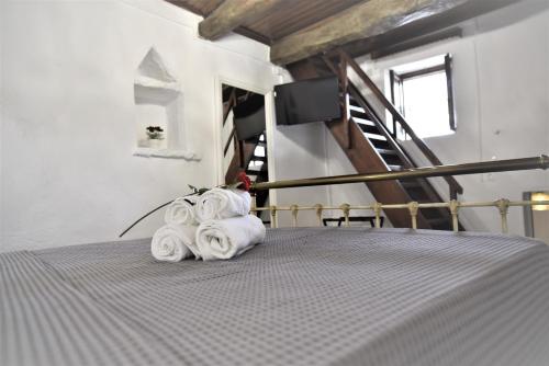 a stack of towels on a bed in a room at Lale's House in Garazo