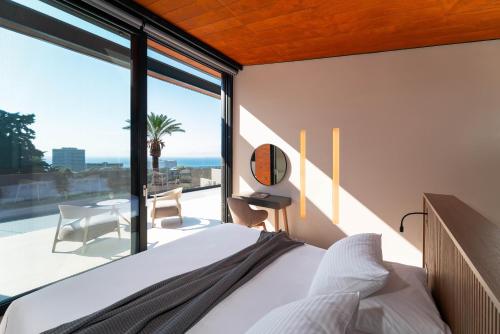 a bedroom with a bed and a large window at Villa Casa Palmera in Ixia