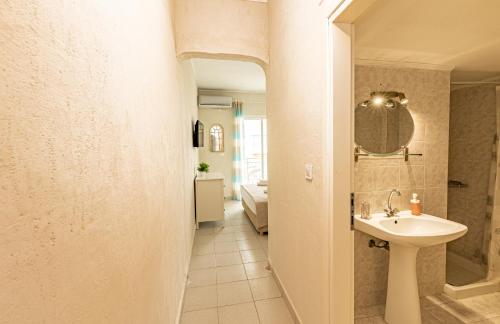 a bathroom with a sink and a mirror at Kordela studios in Nea Skioni