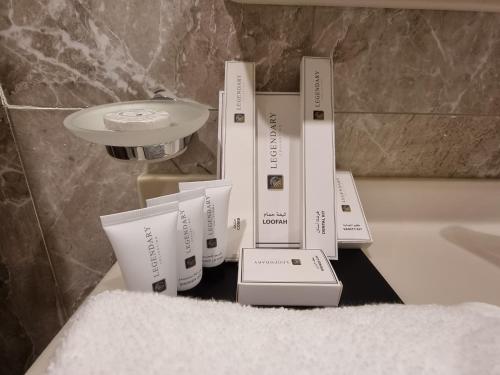 a pile of boxes sitting on a counter in a bathroom at Casa Diora Hotel Jeddah in Jeddah