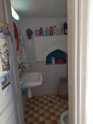 a small bathroom with a sink and a toilet at KARAI in Astypalaia Town