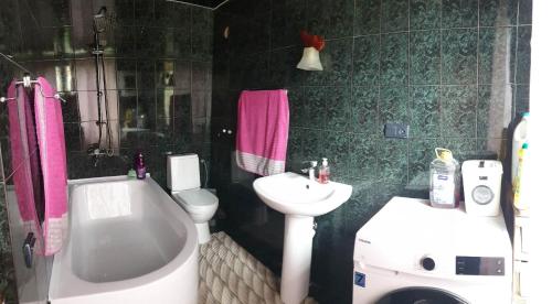 a bathroom with a sink and a toilet and a tub at Nino's apartment-Isolated floor for rent in Tbilisi City