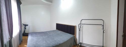 a small room with a bed in a room at Nino's apartment-Isolated floor for rent in Tbilisi City