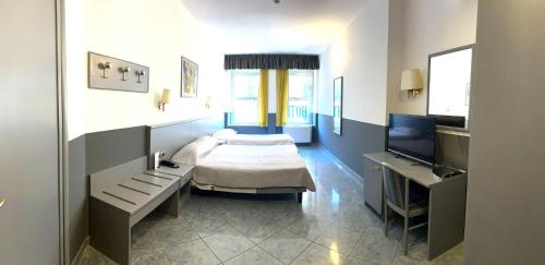 a bedroom with a bed and a television in it at Keb Hotel Vitruvio in Milan