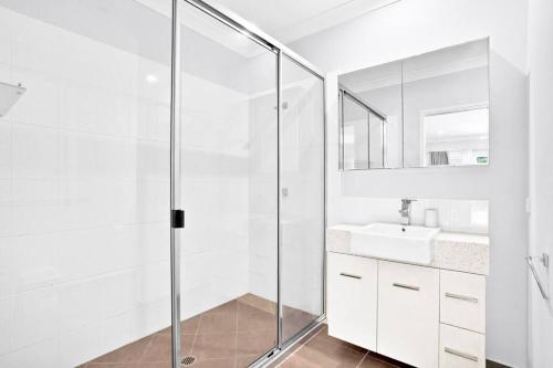 a bathroom with a glass shower and a sink at SeaBreeze Studios ( Room 1 ) - Palm Cove in Palm Cove