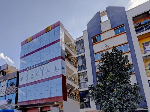 a building with a christmas tree in front of it at Hotel O Compact Studio Kr Puram Near Phoenix Marketcity in Bengaluru