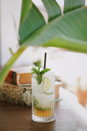 a drink sitting on a table with a green garnishment at Lavinya Otel in Golturkbuku