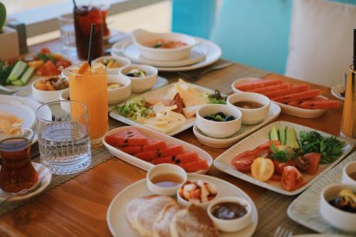 a table with plates of food on a table at Lavinya Otel in Golturkbuku
