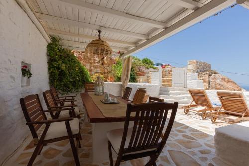 un patio con sillas y una mesa de madera. en Villa Elliah, en Episkopianá