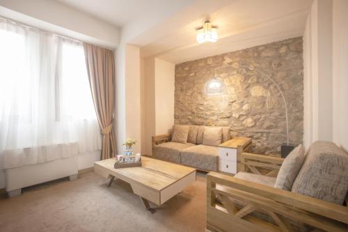 a living room with a couch and a table at Bushi Resort & SPA in Skopje