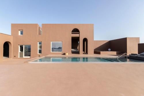 a swimming pool in the middle of a house at Serra Exclusive Suites in Akrotiri