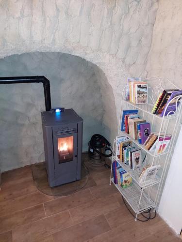 a book shelf with a stove in a room at Penzion Felden in Jablonné v Podještědí