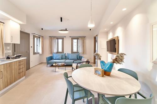 a kitchen and living room with a table and a couch at Sigma Residences Boutique Hotel in Exámbela
