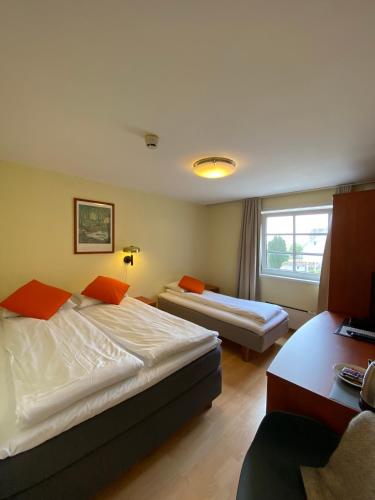 Postel nebo postele na pokoji v ubytování Lilland Brewery Hotel
