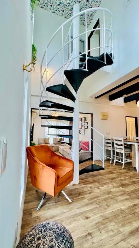 a living room with a spiral staircase in a house at Miyako Blue Villa Kugai in Miyako-jima