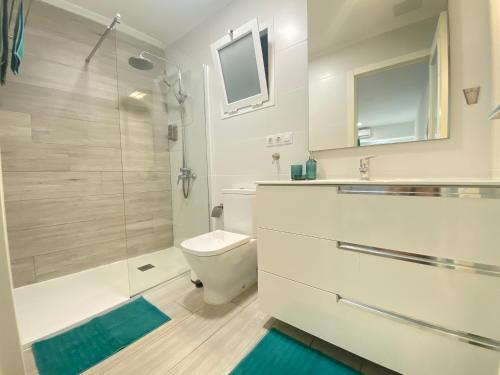 y baño con aseo y ducha acristalada. en Loft en Las Canteras, en Las Palmas de Gran Canaria
