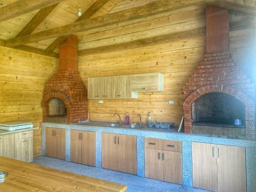 a kitchen with a brick oven in a room at Raven Comstar in Corbu