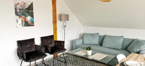 a living room with a couch and a table at Klimatyczny apartament nr 8 z widokiem na góry Sowie in Bielawa