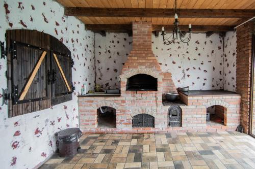 a brick oven in a room with a wall at Casa Arcadia 2 piscina,ciubar in Merei