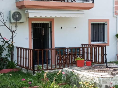 a porch of a house with a wooden railing at Perivoli Tessas' in Parga