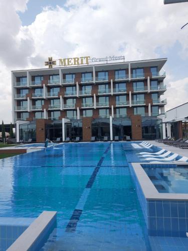 a hotel with a large swimming pool in front of it at Merit Grand Mosta Spa Hotel & Casino in Svilengrad