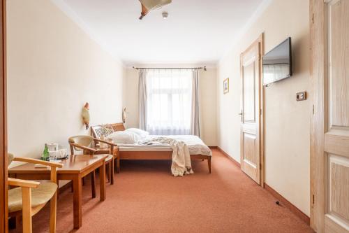 a bedroom with a bed and a table and chairs at Willa Bór in Zakopane