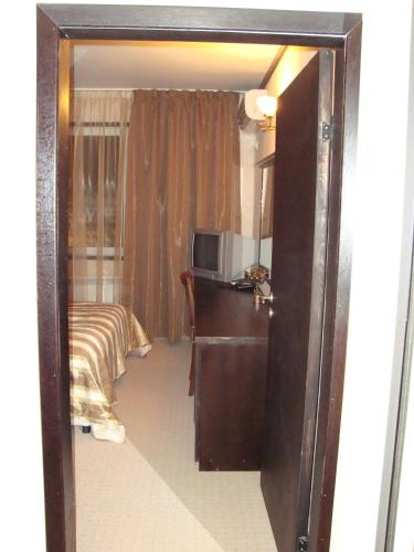 a door leading into a room with a bedroom at Hotel Villa Ofir in Sandanski