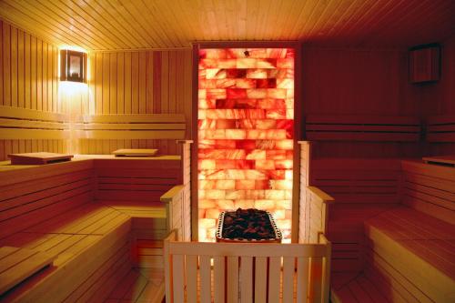 an inside of a sauna with a fireplace at Merit Grand Mosta Spa Hotel & Casino in Svilengrad