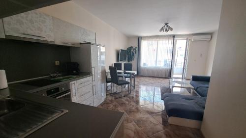 a kitchen and living room with a couch and a table at Luxury Apartment VLADISLAV in Varna City